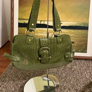 Wilson leather bag in new condition except for the imperfection shown in photo.